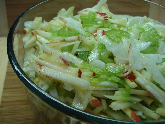 Coleslaw in glass bowl on bamboo mat